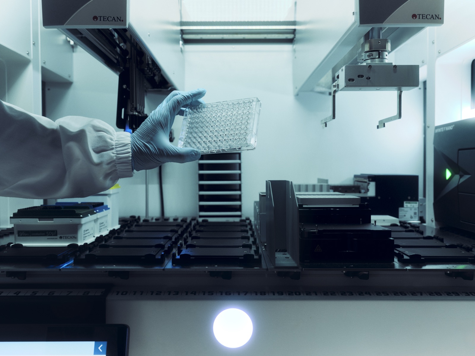 Loading a microplate into the robot.